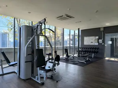 a gym with cardio equipment in a building with windows at The Dorsett Bukit Bintang KL in Kuala Lumpur