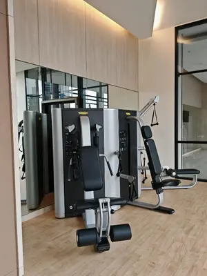 a room with a gym with two chairs in it at Kuala Lumpur Services Apartments In A X O N Residence in Kuala Lumpur