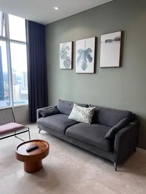a living room with a couch and a table at Sky suites klcc Family suites home in Kuala Lumpur