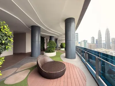 a bench on the balcony of a building at IKON SUITE's E A T O N KLCC in Kuala Lumpur