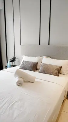two beds with white sheets and pillows in a bedroom at Axon premier suites, Near pavilion Bukit bingtang Kuala Lumpur in Kuala Lumpur