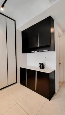 a kitchen with black cabinets and a counter top at Axon premier suites, Near pavilion Bukit bingtang Kuala Lumpur in Kuala Lumpur