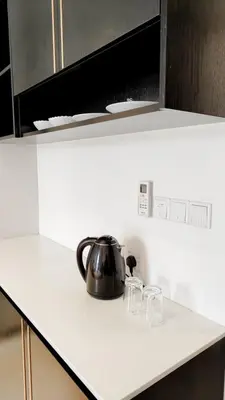 a tea kettle and glasses on a kitchen counter at Axon premier suites, Near pavilion Bukit bingtang Kuala Lumpur in Kuala Lumpur