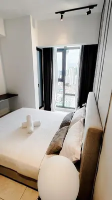 a bedroom with a large bed with a large window at Axon premier suites, Near pavilion Bukit bingtang Kuala Lumpur in Kuala Lumpur