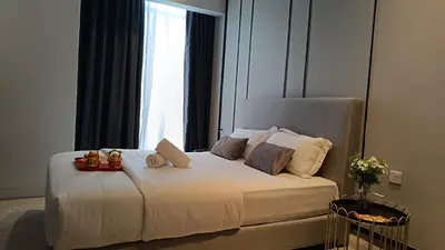 a bedroom with a white bed with a window at Axon premier suites, Near pavilion Bukit bingtang Kuala Lumpur in Kuala Lumpur