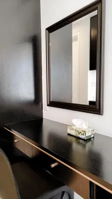 a bathroom with a mirror and a black counter at Axon premier suites, Near pavilion Bukit bingtang Kuala Lumpur in Kuala Lumpur