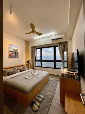 a bedroom with a bed and a large window at Bukit Bintang Service Apartment in Kuala Lumpur