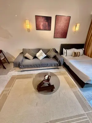 a living room with a couch and a bed at Bukit Bintang Service Apartment in Kuala Lumpur