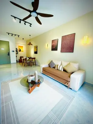 a living room with a couch and a ceiling fan at Bukit Bintang Service Apartment in Kuala Lumpur