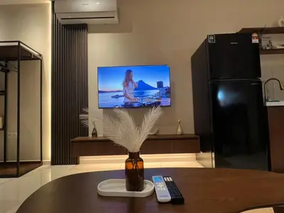 a living room with a table with a tv on the wall at Majestic Residence at KLCC By Fortune in Kuala Lumpur
