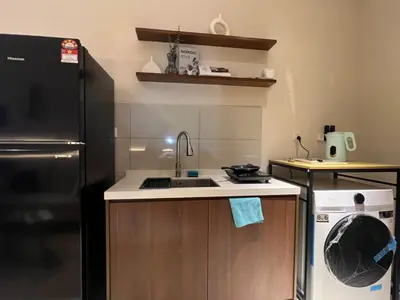 a kitchen with a sink and a black refrigerator at Majestic Residence at KLCC By Fortune in Kuala Lumpur