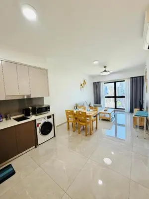 a kitchen and living room with a table and chairs at Agile Bukit Bintang TRX By RUP Suites in Kuala Lumpur