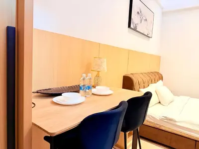 a dining room table with two chairs and a bed at The luxe by Kuala Lampur City in Kuala Lumpur