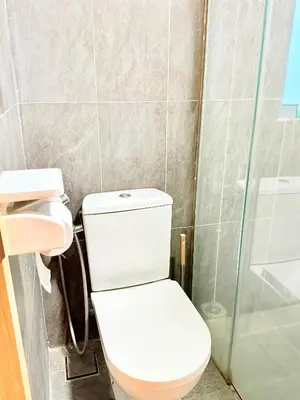 a bathroom with a toilet and a glass shower at The luxe by Kuala Lampur City in Kuala Lumpur