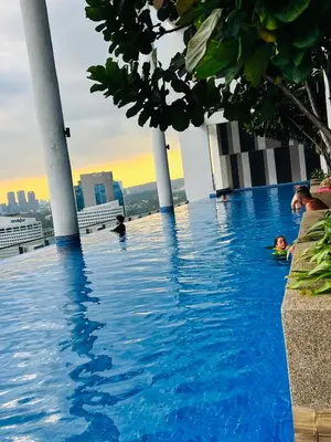 a pool on the roof of a building with people in it at Sky property by klcc in Kuala Lumpur