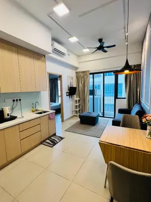 a kitchen and living room with a couch and a table at Sky property by klcc in Kuala Lumpur