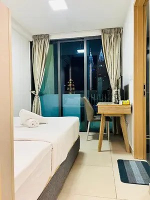 a bedroom with a bed and a desk and a table at Sky property by klcc in Kuala Lumpur