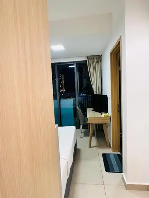 a bedroom with a bed and a desk with a computer at Sky property by klcc in Kuala Lumpur
