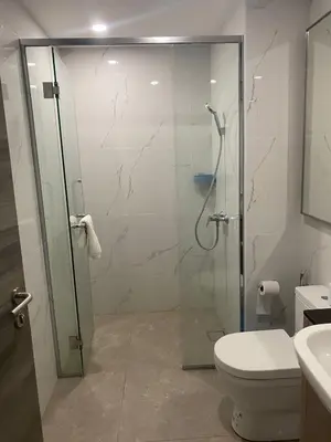a bathroom with a glass shower and a toilet at agile residence in Kuala Lumpur