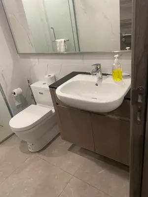 a bathroom with a sink and a toilet and a mirror at agile residence in Kuala Lumpur