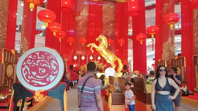 a group of people standing in a mall with a lion statue at Sky Residence at TRION KL in Kuala Lumpur