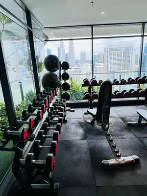 a gym with a row of dumbbells in front of a window at Sky property infinitum 2 in Kuala Lumpur