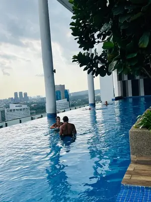 two people swimming in a swimming pool on a building at Sky property infinitum 2 in Kuala Lumpur