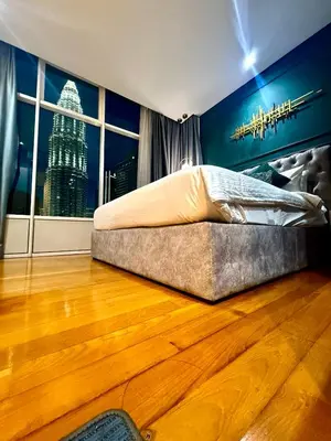 a bedroom with a bed and a large window at Sky Suites Klcc By Bukit Bintang in Kuala Lumpur
