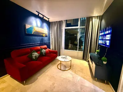 a living room with a red couch and a tv at Sky Suites Klcc By Bukit Bintang in Kuala Lumpur