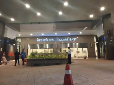 a man is standing in front of a store at BTS Service suite at time square in Kuala Lumpur