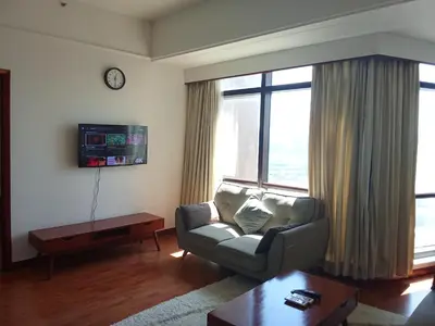 a living room with a couch and a large window at BTS Service suite at time square in Kuala Lumpur
