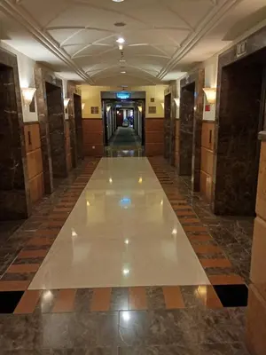 a hallway in a building with a tile floor at BTS Service suite at time square in Kuala Lumpur