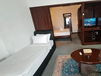 a room with a bed and a table and a tv at Time square midnight suites KL in Kuala Lumpur