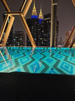 a view of a city skyline at night from a building at Scarletz Suites KLCC by near twin tower in Kuala Lumpur