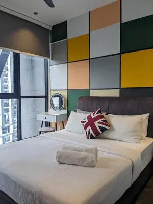 a bedroom with a large bed with a colorful wall at Alion Sutis KLCC At Scarlets in Kuala Lumpur