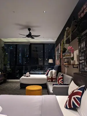 a living room with a couch and a ceiling fan at Alion Sutis KLCC At Scarlets in Kuala Lumpur