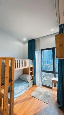 a bedroom with two bunk beds and a window at 3BR family friendly Apartment at The Elements Ampang Kuala Lumpur in Kuala Lumpur