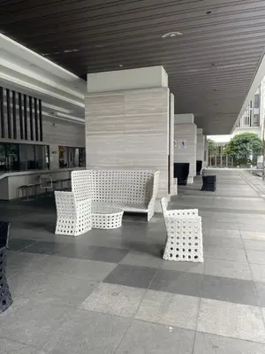 a lobby with white benches in a building at 3BR family friendly Apartment at The Elements Ampang Kuala Lumpur in Kuala Lumpur