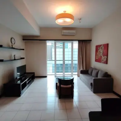 a living room with a couch and a tv at Abadi Inn in Kuala Lumpur