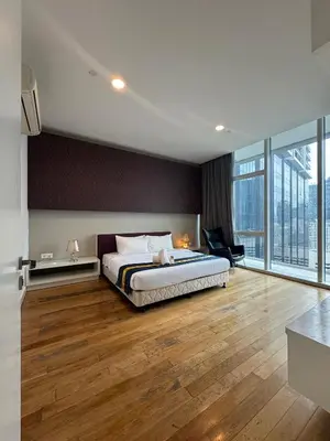 a bedroom with a large bed and a large window at Oras Suites At platinum KLCC in Kuala Lumpur