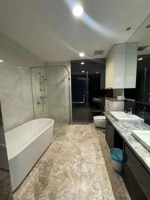 a bathroom with two sinks and a tub and a toilet at Oras Suites At platinum KLCC in Kuala Lumpur