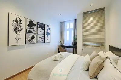 a bedroom with a large white bed and a desk at Met 1 Mont Kiara - 3 min to Publika Mall - 2B2B for 4 in Kuala Lumpur