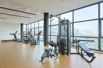 a gym with a row of treadmills and machines at Met 1 Mont Kiara - 3 min to Publika Mall - 2B2B for 4 in Kuala Lumpur