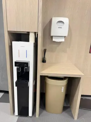 a small kitchen with a coffee dispenser and a trash can at KLCC VIEW RESIDENC, I M P E R I A L , By LUXORA in Kuala Lumpur
