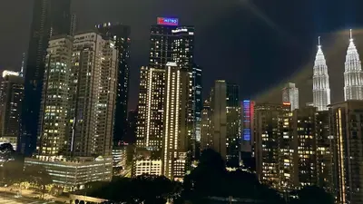 a night view of a large city with tall buildings at Dreamy KLCC Luxury Haven in Kuala Lumpur