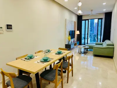 a dining room table and chairs in a living room at Dreamy KLCC Luxury Haven in Kuala Lumpur