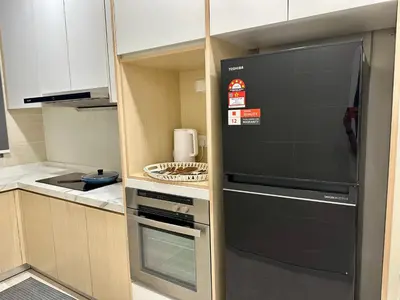 a kitchen with a black refrigerator in a kitchen at Dreamy KLCC Luxury Haven in Kuala Lumpur