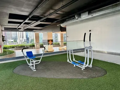 two chairs sitting in a room with green grass at Dreamy KLCC Luxury Haven in Kuala Lumpur