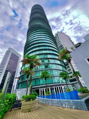 a tall building with a pool in front of it at Vortex in Kuala Lumpur