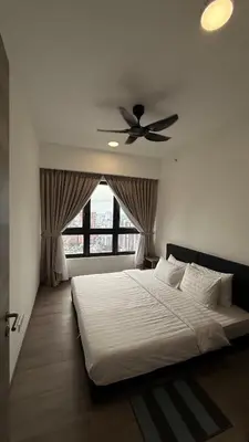 a bedroom with a bed with a ceiling fan at Agile Residence Sky View Suites in Kuala Lumpur